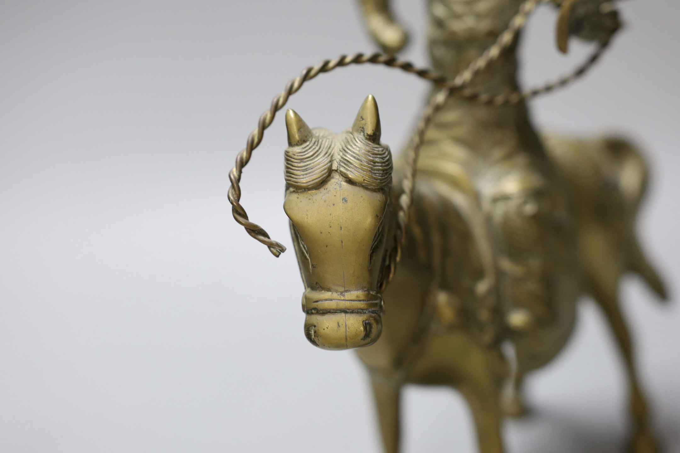 An early 20th century Chinese bronze group of Guandi riding a horse, 24 cms high